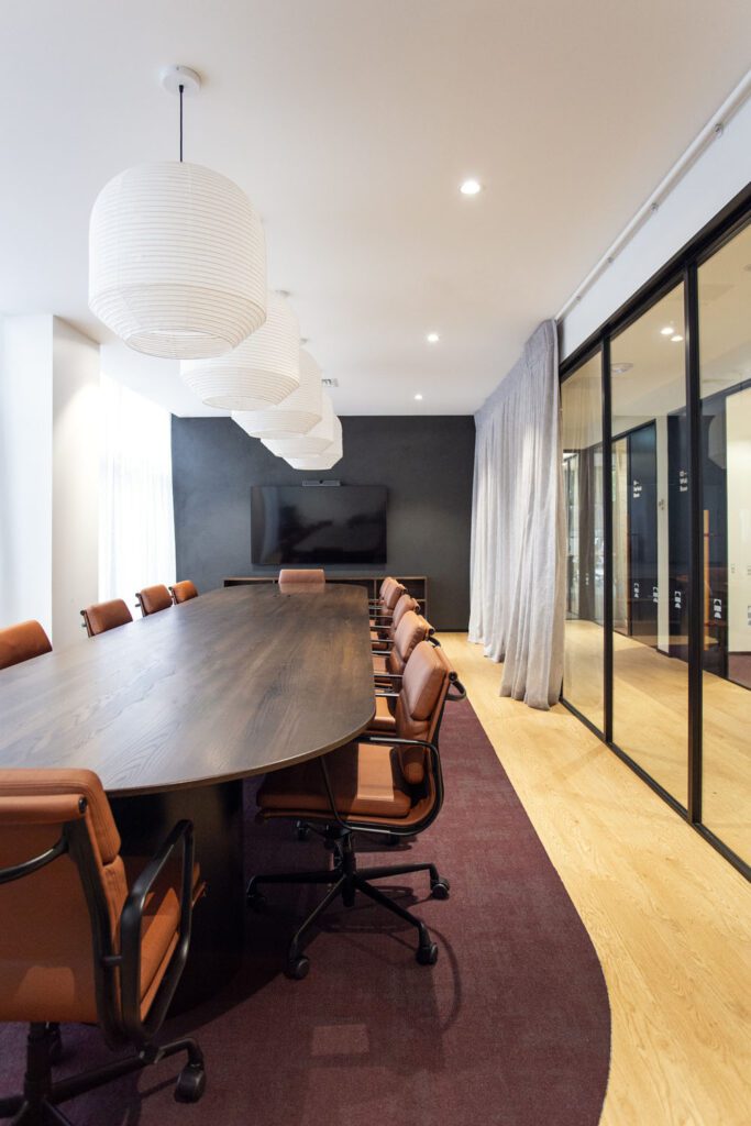 Private office space for Lodge Real Estate, eames replica chairs, with a dark oak meeting table. Modern office look.